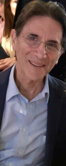 Photo of Lou Giansante with brown hair and rimless glasses